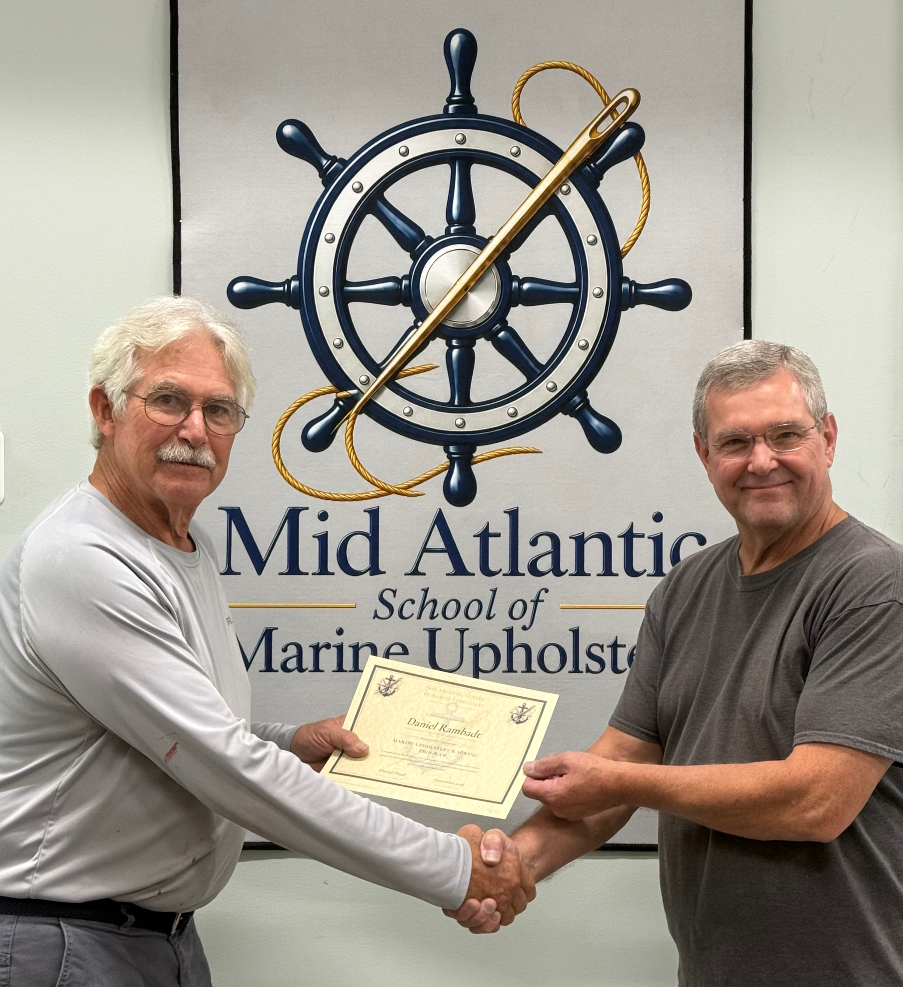 David Peed presenting a Marine Upholstery certificate to a graduating student