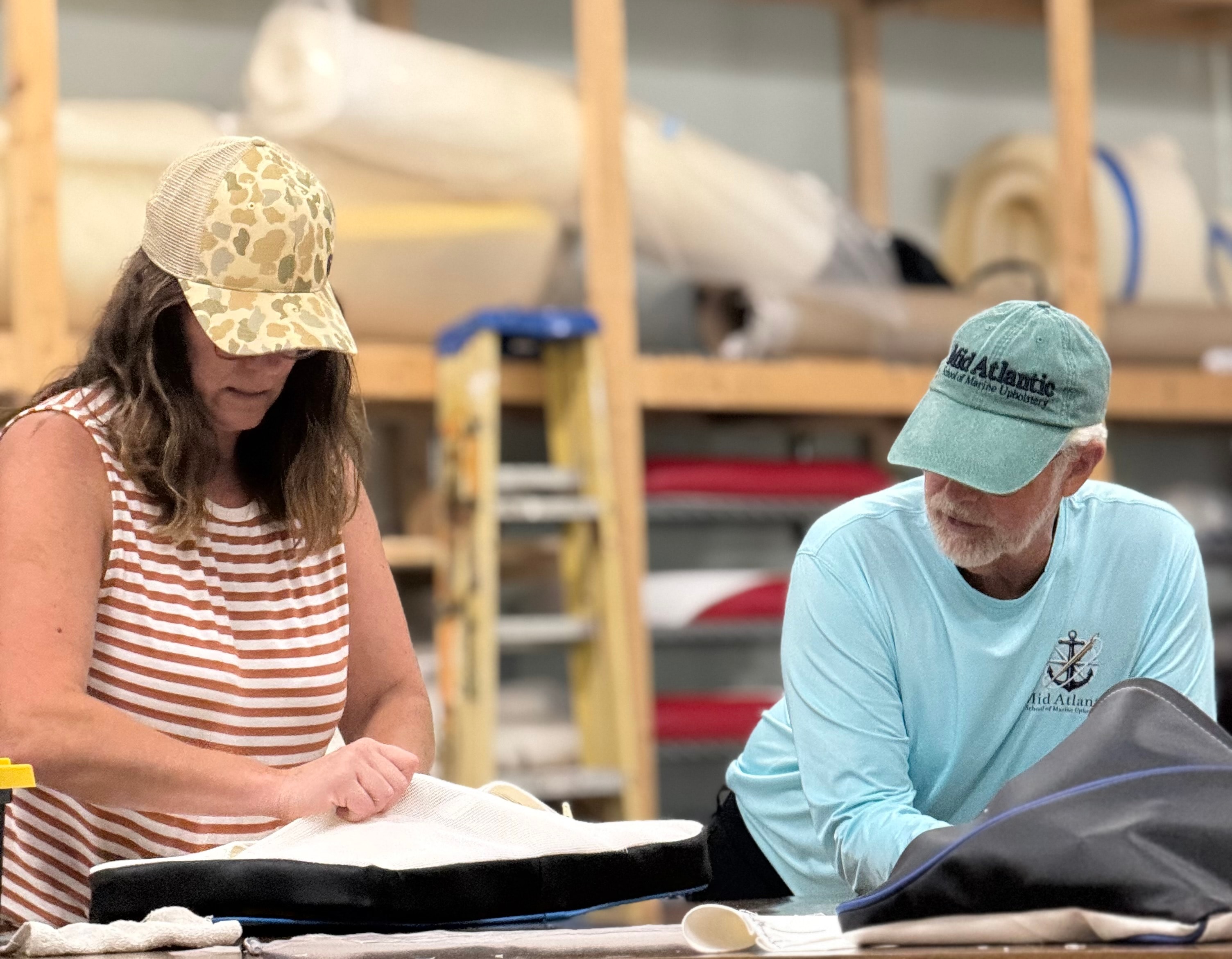 Students reviewing boat upholstery plans at Mid Atlantic School of Marine Upholstery