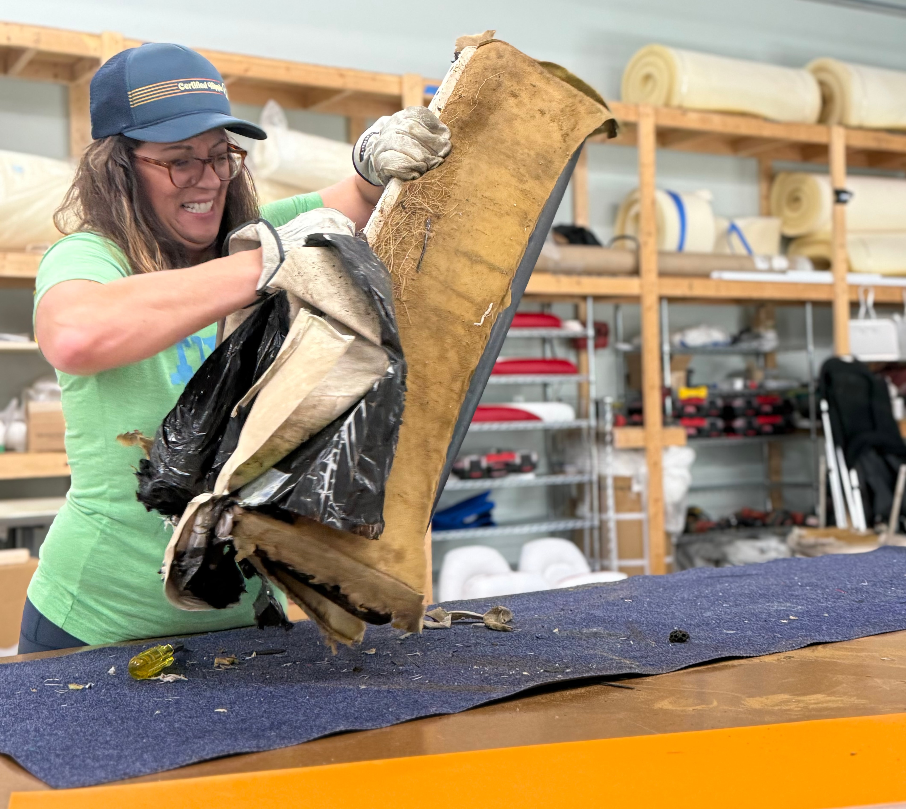 Student stripping old boat upholstery at Mid Atlantic School of Marine Upholstery