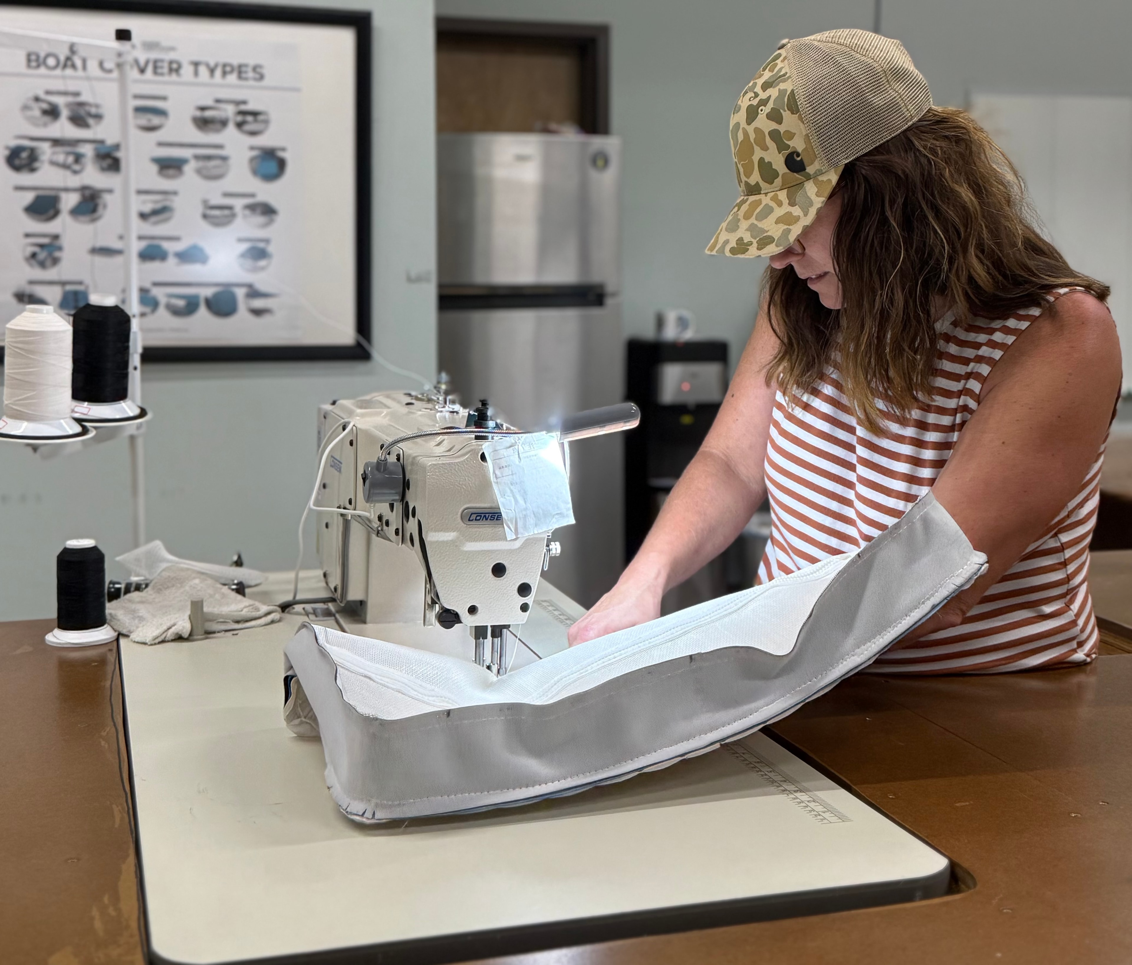 Student sewing a boat cushion on industrial machine at Mid Atlantic School of Marine Upholstery