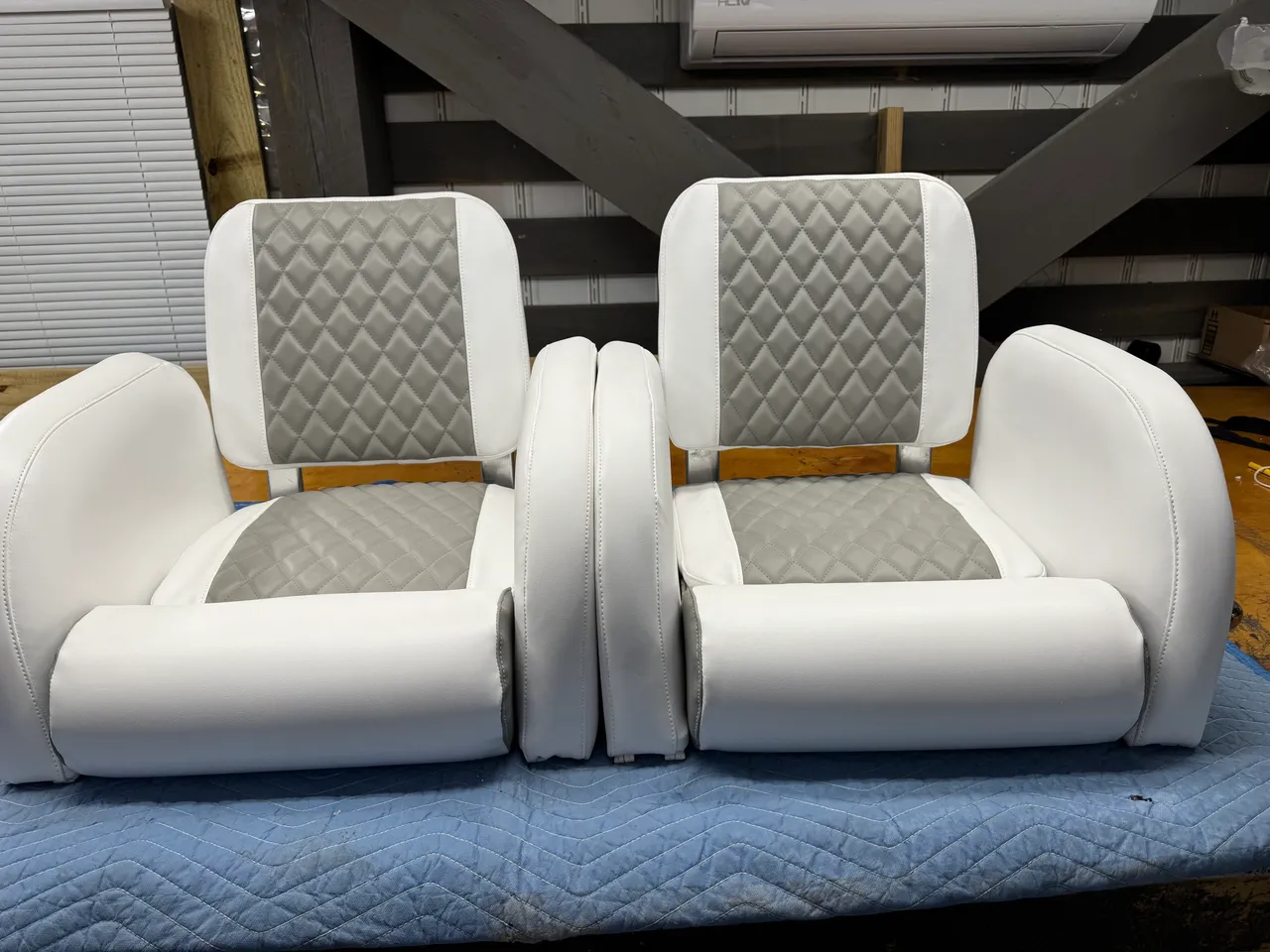Tan quilted marine cushion on workshop bench