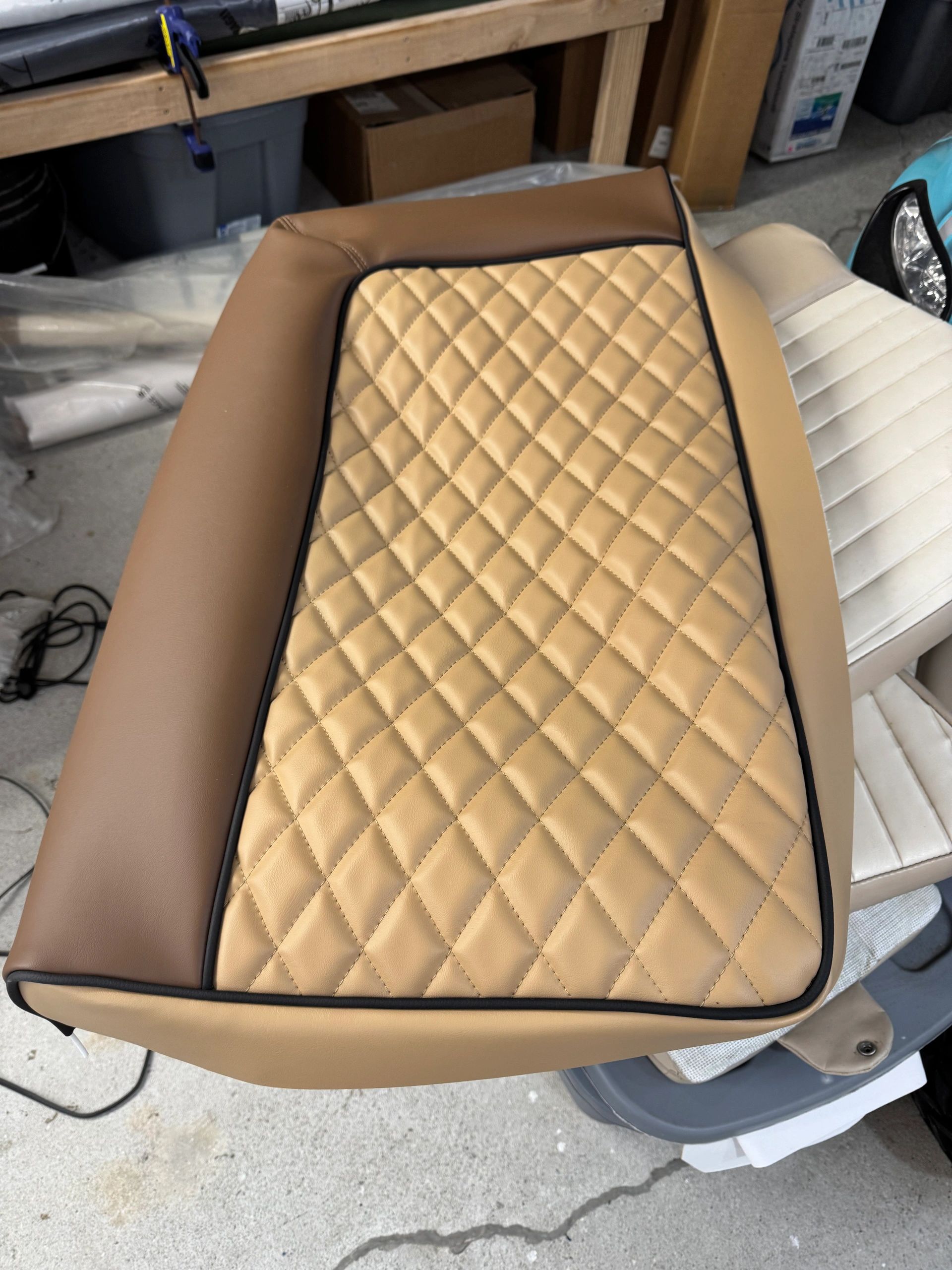 Tan quilted marine cushion on workshop bench