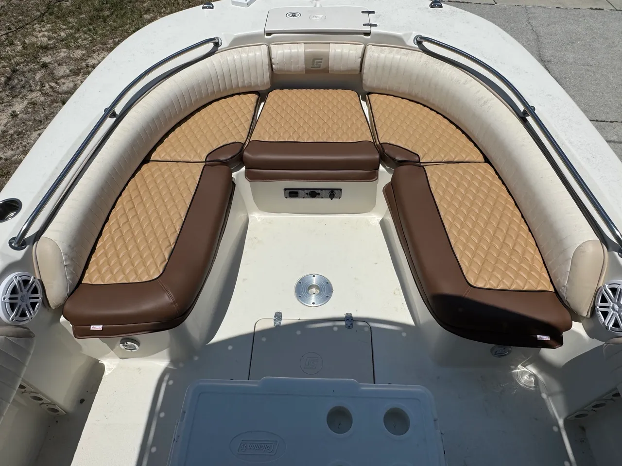 Tan and brown diamond-quilted bow seating with center armrest — overhead view