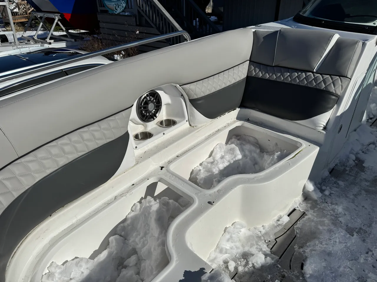 Gray and white diamond-quilted boat interior seating with speaker pod