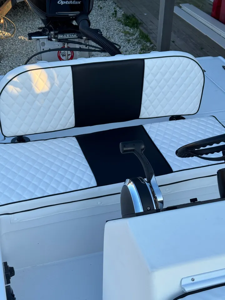 White and black diamond-quilted boat seating with center console