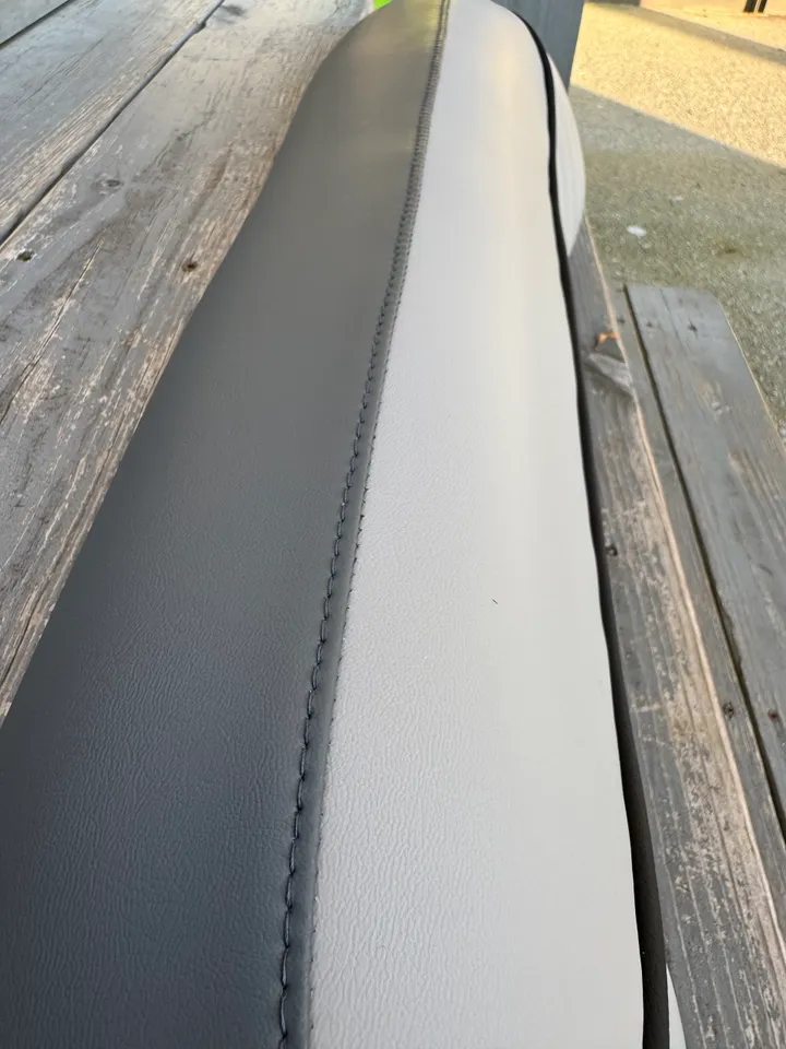 Close-up of two-tone gray marine vinyl with precision saddle stitching