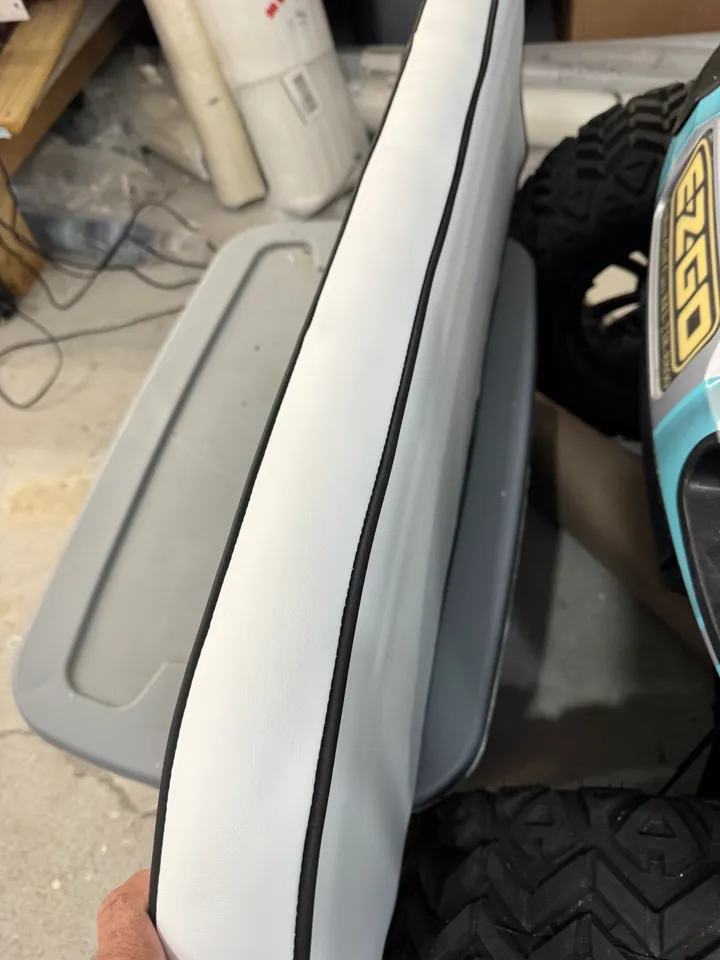 White marine cushion edge showing precision black welt piping detail