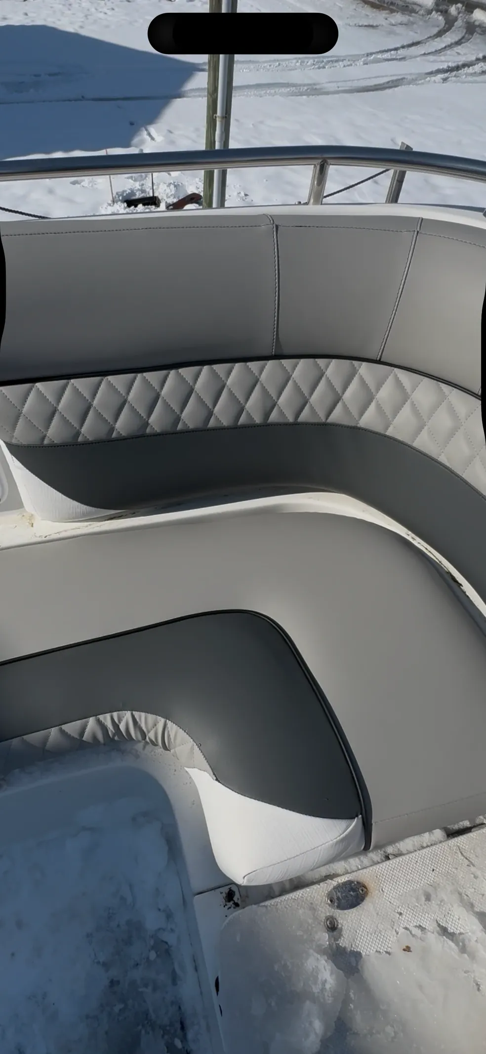 Gray and white curved boat bench seating with diamond quilted accent strip